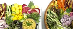 colorful spread of fresh vegetables in a bowl and platter