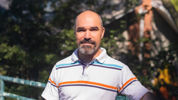 photo of a man smiling in a striped shirt