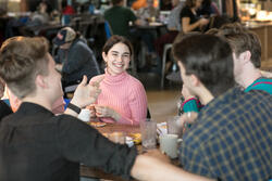 Student smiling at a table in the Met